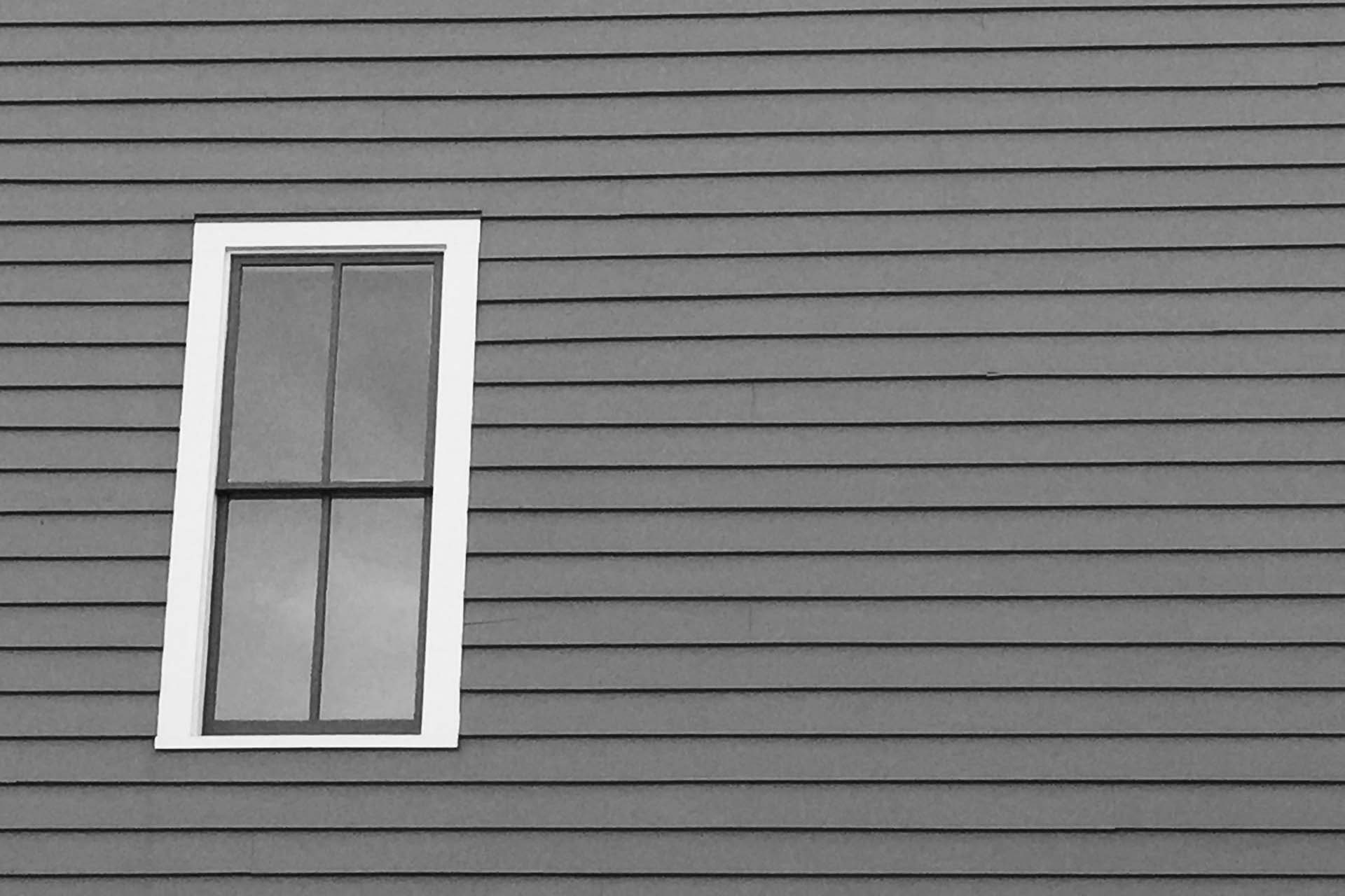 What Causes Holes in Vinyl Siding?